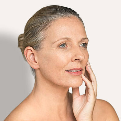 Middle-aged woman touching face