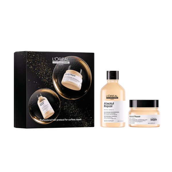 L'Oréal Paris Hairdressers Absolut Repair and Build Repair hair care set, featuring a black gift box with gold glitter accents, a beige bottle, and a beige jar with black lids, shown on a white background.