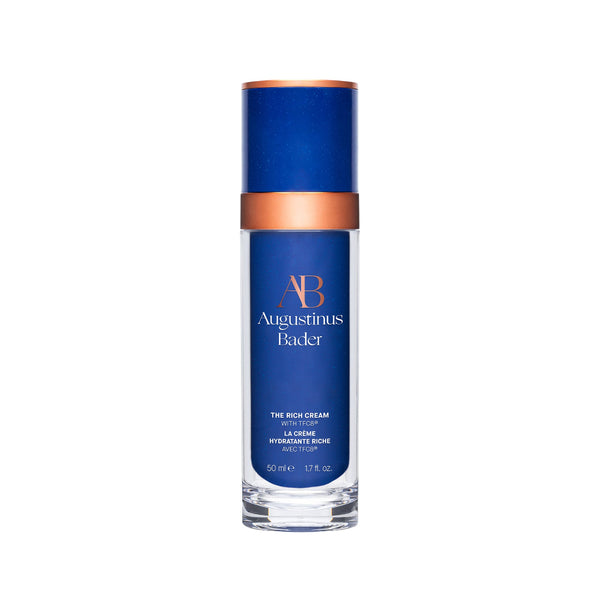 Blue skincare bottle with bronze cap on a white background