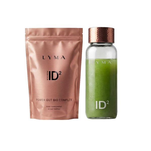 LYMA IDยฒ Power Gut Bio Complex food supplement set, featuring a metallic rose gold pouch next to a clear glass bottle filled with green powder and topped with a copper-colored cap.