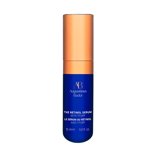 Blue serum bottle with orange cap on a white background