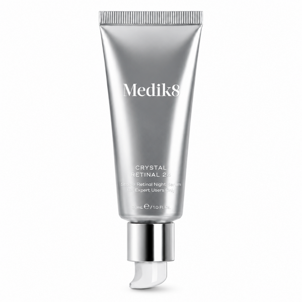 Medik8 Crystal Retinal 240 Retinol Night Serum in a sleek, metallic silver squeeze tube with a reflective silver cap and a clear, curved applicator tip, set against a solid white background.