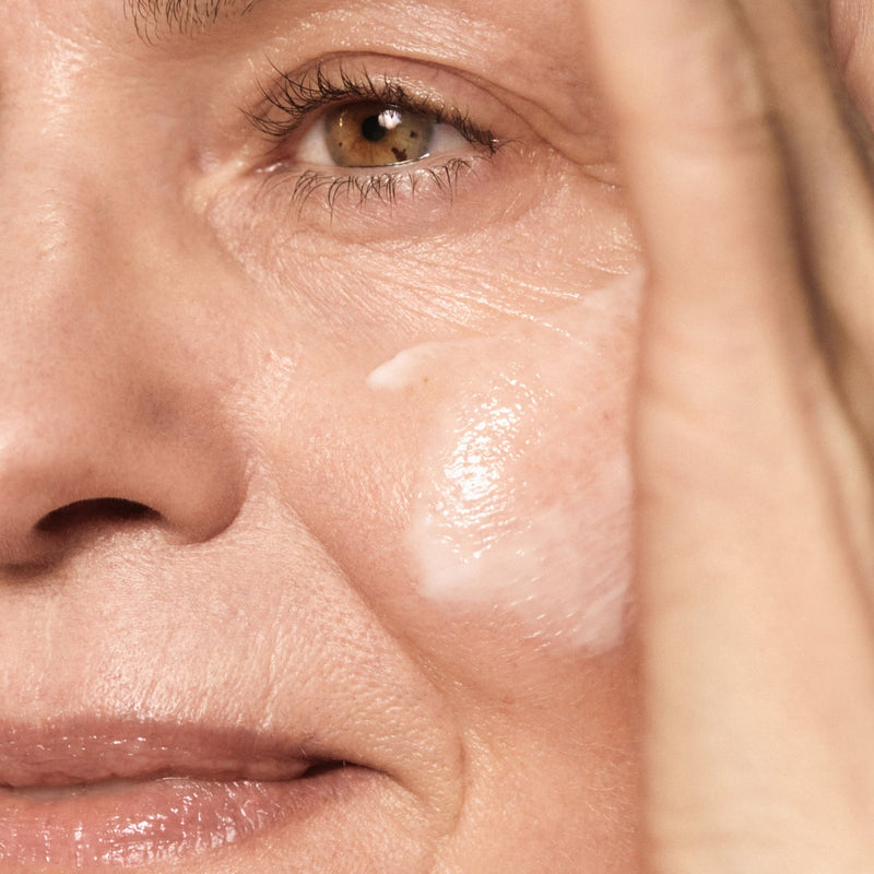 Close-up of a person's face with visible skin texture and wrinkles.