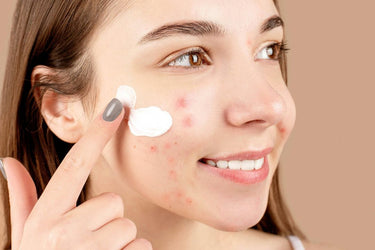 close up image of girl applying sunscreen to her face