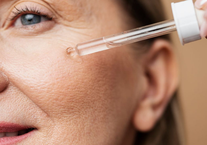 lady applying serum to her face