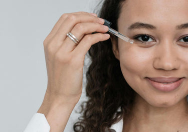 Lady applying serum to her face