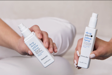 two hands holding This Works Deep Pillow Spray and Sleep Plus Pillow Spray