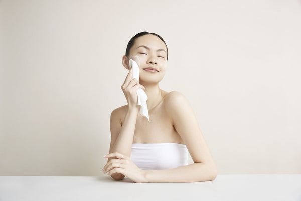 a woman applying Decree Deep Cleanse to her cheek