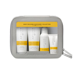 Philip Kingsley Body Building Discovery Collection for fine hair in a light gray zippered pouch, containing four white hair care bottles and tubes with yellow accents.