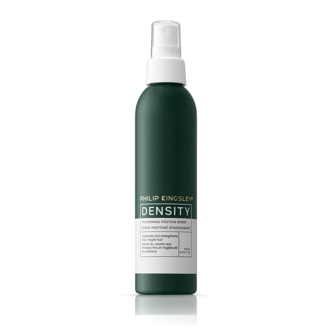 Green spray bottle with white cap labeled 'Philip Kingsley Density' on a white background