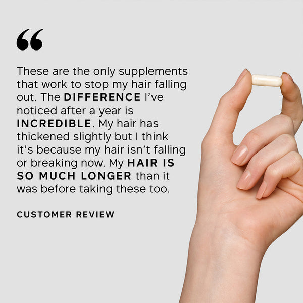 Hand holding a supplement capsule with customer review text on a light gray background