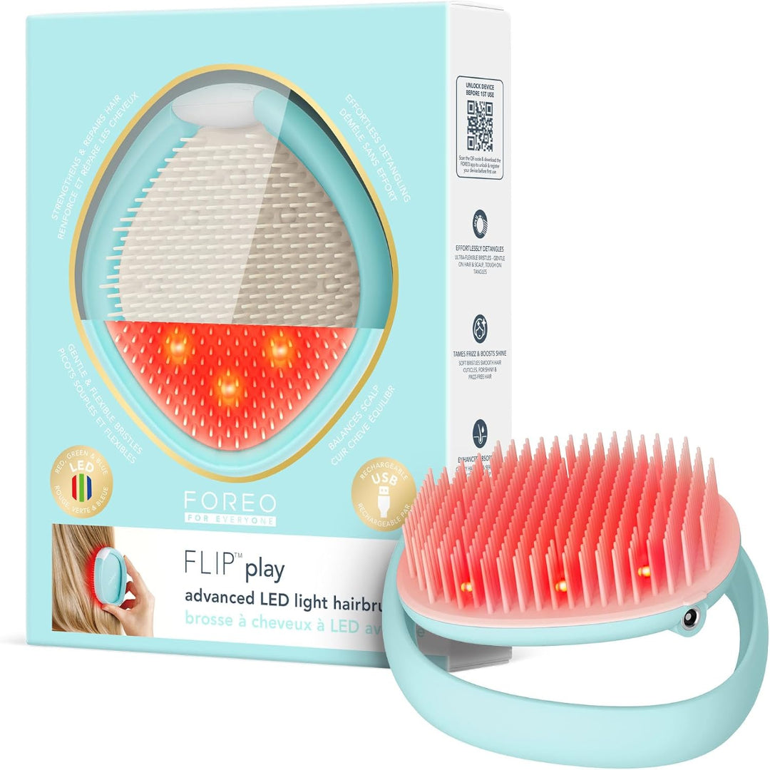 FOREO FLIP play advanced LED light hair brush shown with its light blue retail box on a white background. The brush has a mint blue handle and bristles glowing red from the active LED light therapy, with the packaging displaying the same design.