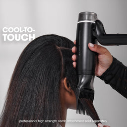 Person using a hair dryer on another person's hair with 'Cool to Touch' text.