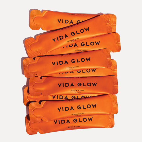 Stack of Vida Glow supplement bars on a white background