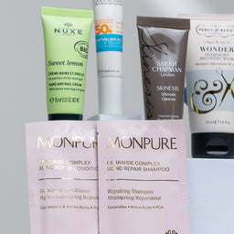 Collection of skincare and hair care products on a gray background