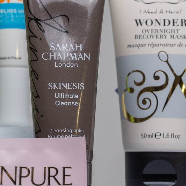 Collection of skincare products including a tube of Sarah Chapman Skinesis Ultimate Cleanse and a tube of Percy & Reed's Wonder Overnight Recovery Mask.
