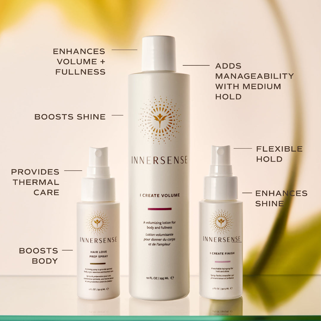 Three Innersense hair care bottles arranged on a warm beige background with callout text describing each product's benefits: a larger white bottle labeled 'I Create Volume' in the center, a smaller white pump bottle labeled 'Hair Love Hair Spray' on the left, and a small white spray bottle labeled 'I Create Fine' on the right.