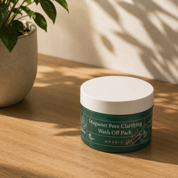Green jar of Mugwort Pore Clarifying Wash Off Pack on a wooden surface with a plant in the background