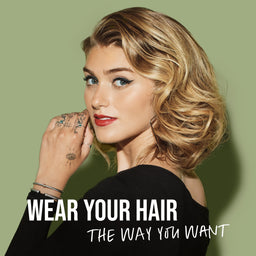 Woman with styled hair against a green background with text 'Wear Your Hair The Way You Want'.