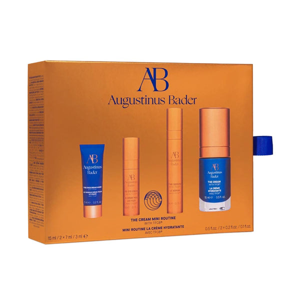 Augustinus Bader skincare product set with orange and blue packaging on a white background