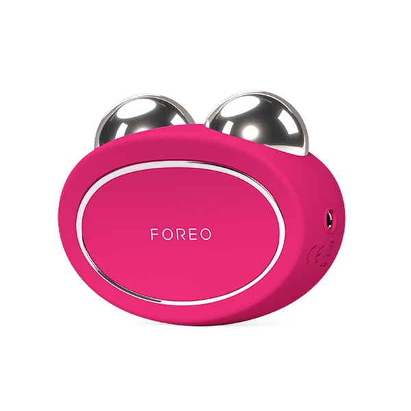 A pink FOREEO facial massage device with two metallic silver ball rollers on top, shown on a plain white background.