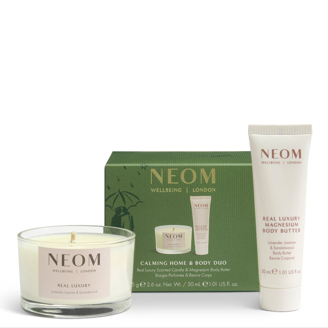 NEOM Welbeing London Calming Home & Body Duo gift set, featuring a green gift box, a white body butter tube, and a white scented candle in a clear glass jar, arranged on a white background.