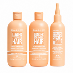 Three peach-colored Hairburst hair care bottles on a white background: Longer Stronger Hair shampoo, conditioner, and hydrating & balancing scalp tonic.