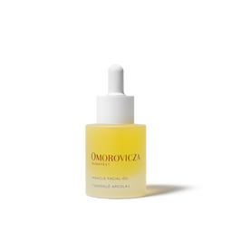 A bottle of Omorovicza Miracle Facial Oil with a white dropper cap, containing a pale yellow liquid, set against a clean white background.