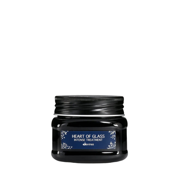 A black jar of d'orés Heart of Glass Intense Treatment with a dark blue label, centered against a solid white background.