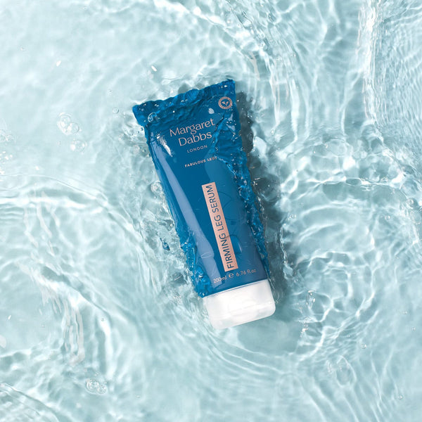 Blue tube of Margaret Dabbs Firming Leg Serum on water surface