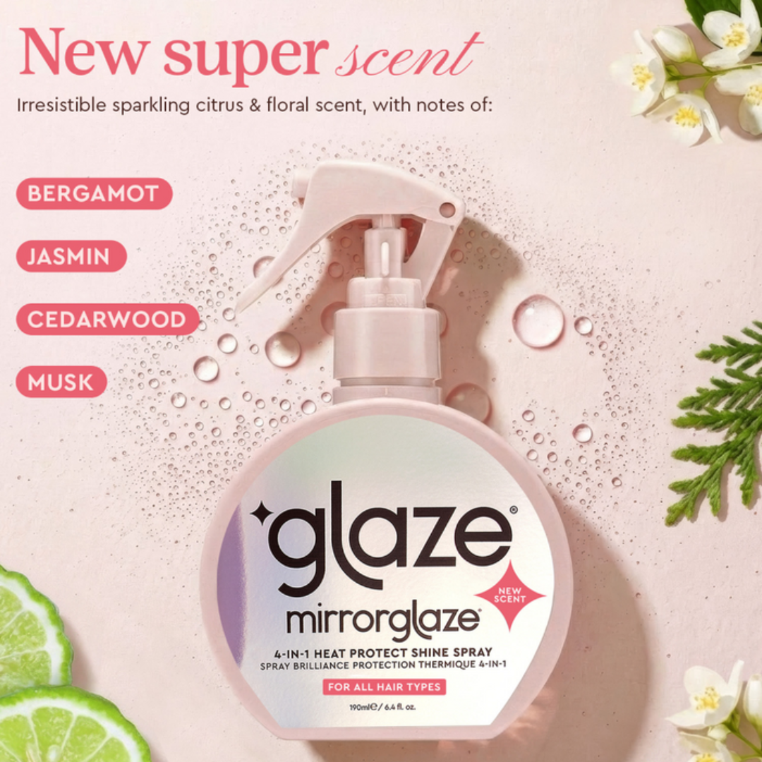 Mirrorglaze hair spray bottle with floral and citrus elements on a light pink background