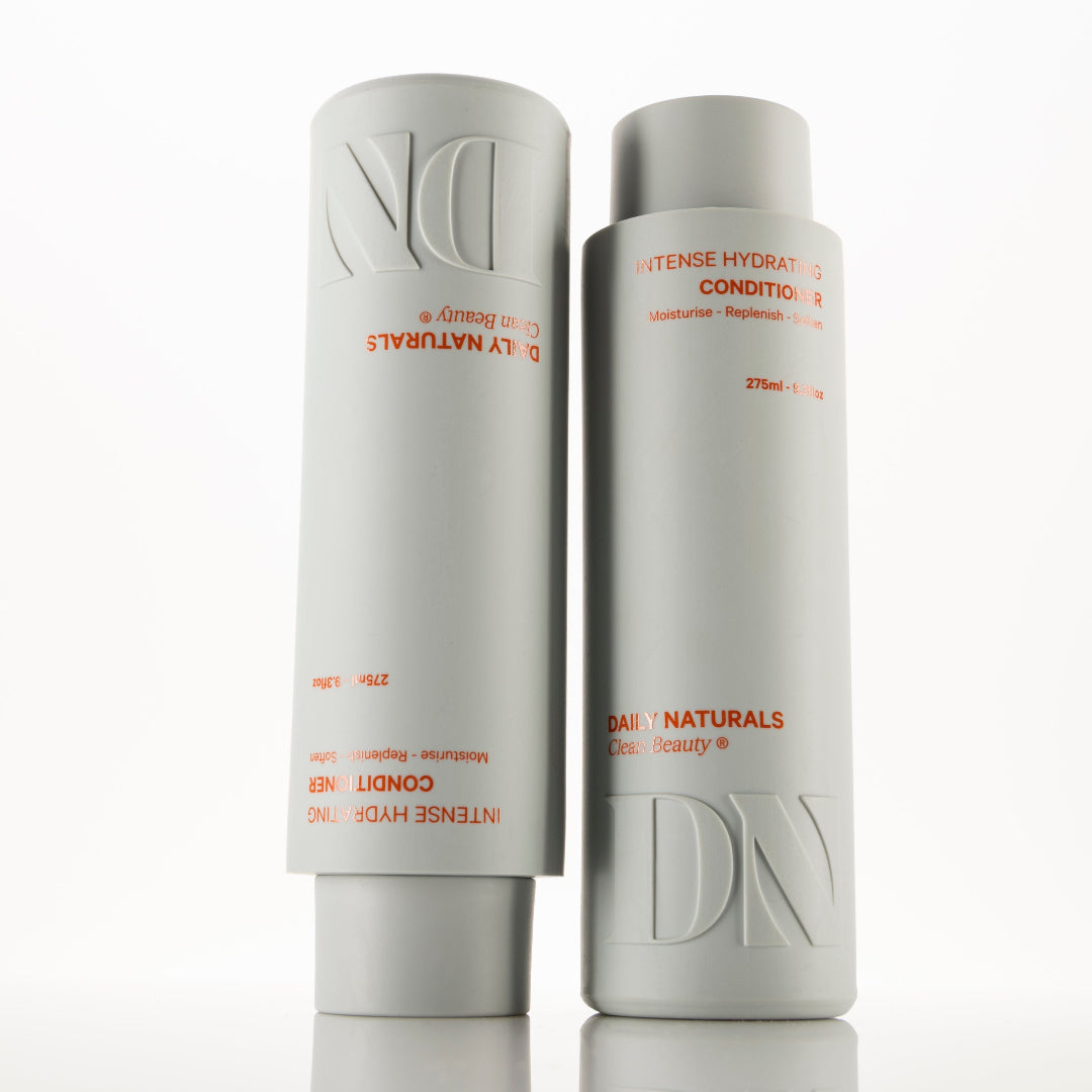 Two bottles of Daily Naturals hair care products on a white background
