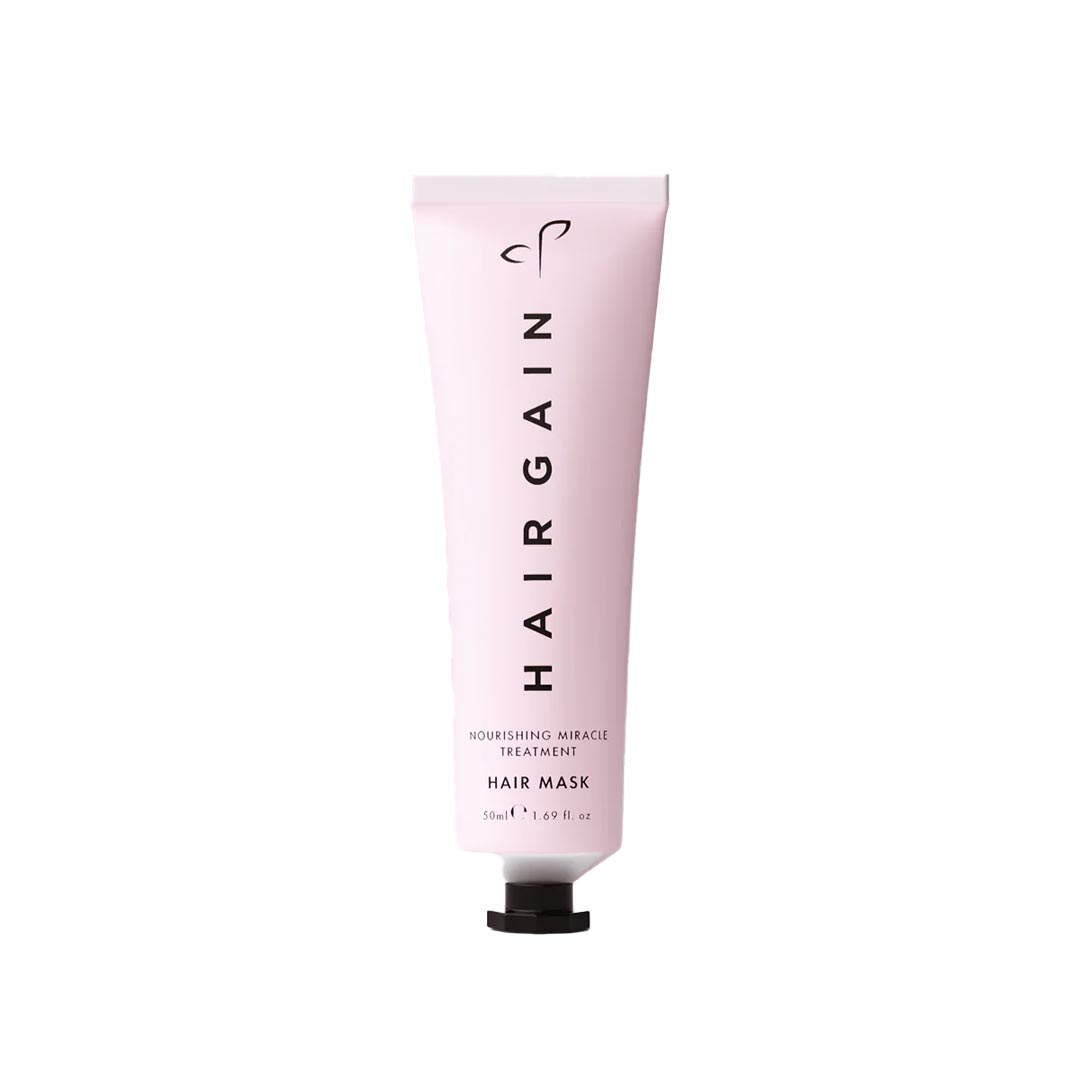 Pink tube of HairGain hair mask on a white background