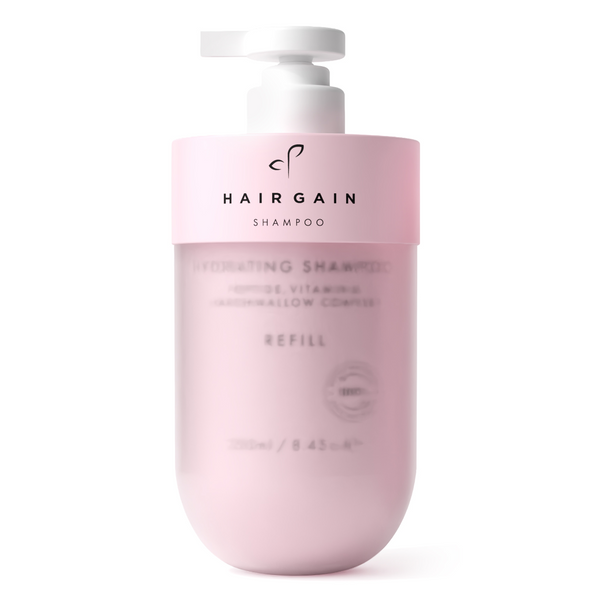 A pink bottle of Hairgain Hydrating Shampoo refill with a white pump dispenser, shown on a clean white background.
