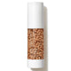 A cylindrical cosmetic bottle filled with tan-colored beads, featuring a white cap and base with the brand name 'Tetra Tidy' visible on the side, set against a plain white background with a soft shadow.