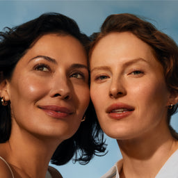 Two women with a clear blue sky background