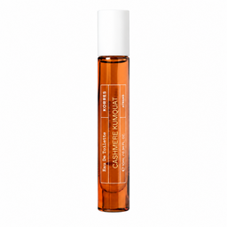 A clear glass rollerball perfume bottle filled with amber liquid, featuring a white cap and white text that reads 'CASHMERE KUMQUAT' and 'KORRES'.