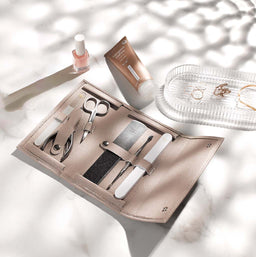 Manicure set with tools on a light surface