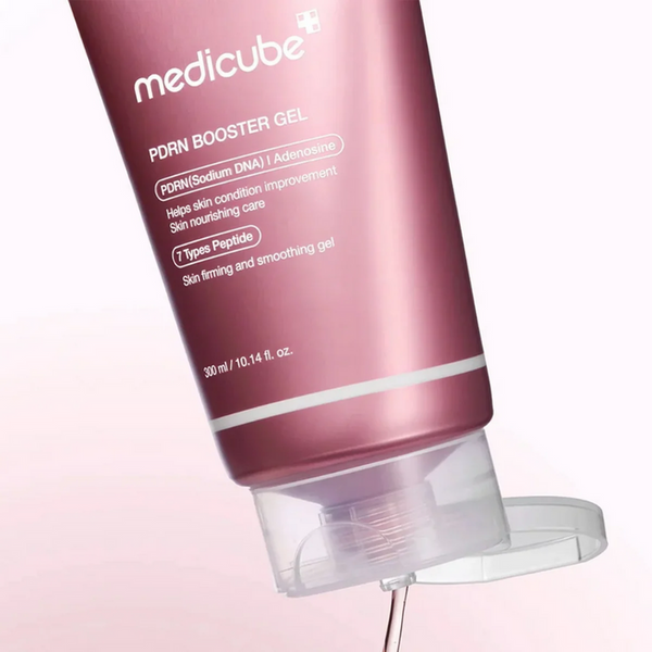 Medicube PDRN Booster Gel tube on a light pink background