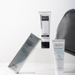 Two tubes of Avene skincare products on a white background