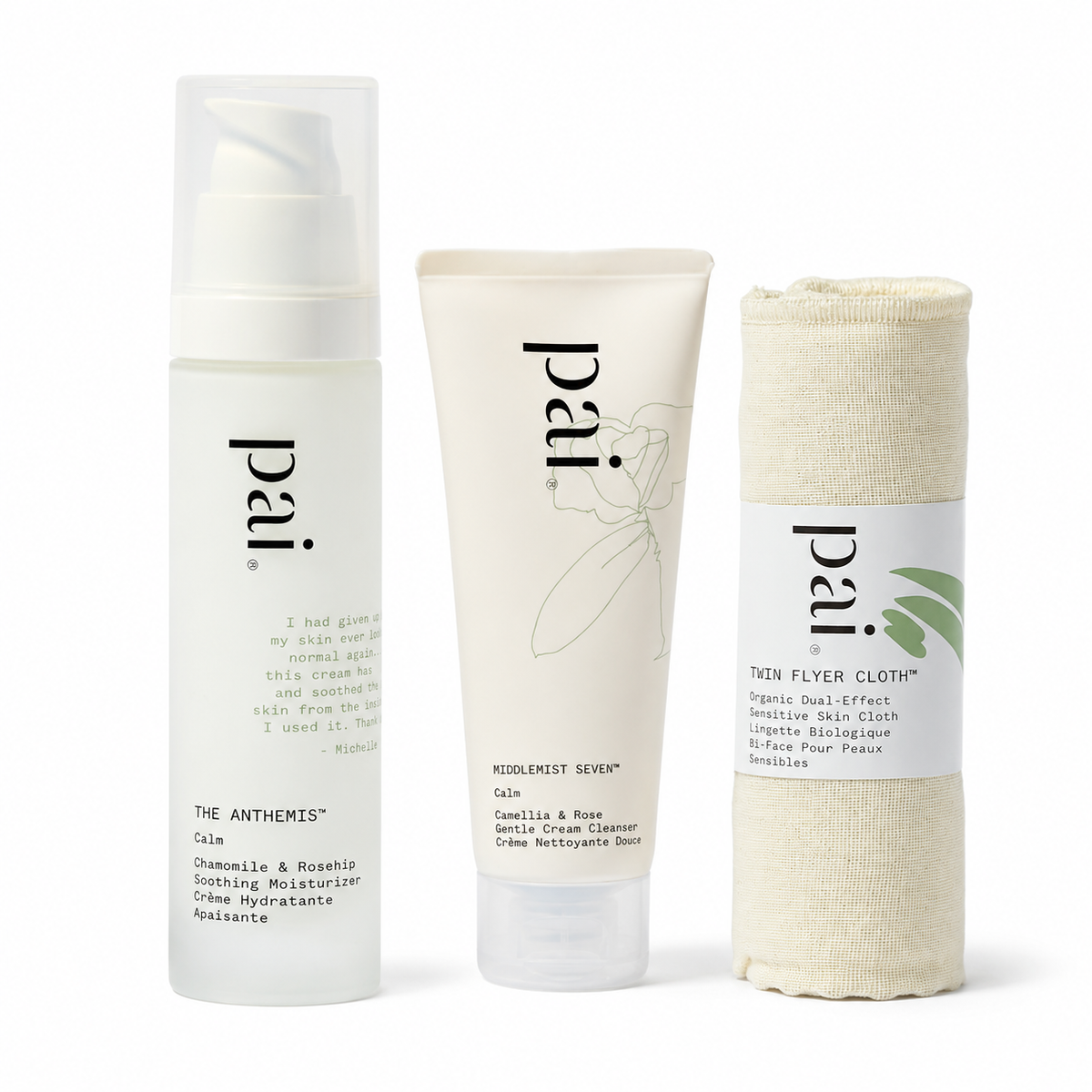 Three Pai skincare and bath products on a white background: a white pump bottle labeled The Anthers Calm, a white tube labeled Kiehl's Silver Calm, and a rolled beige towel labeled The Flyer Cloth.