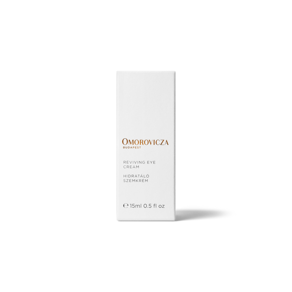 Omorovicza Budapest Reviving Eye Cream in a tall, minimalist white rectangular box with elegant gold and black text, set against a clean white background with a soft shadow.
