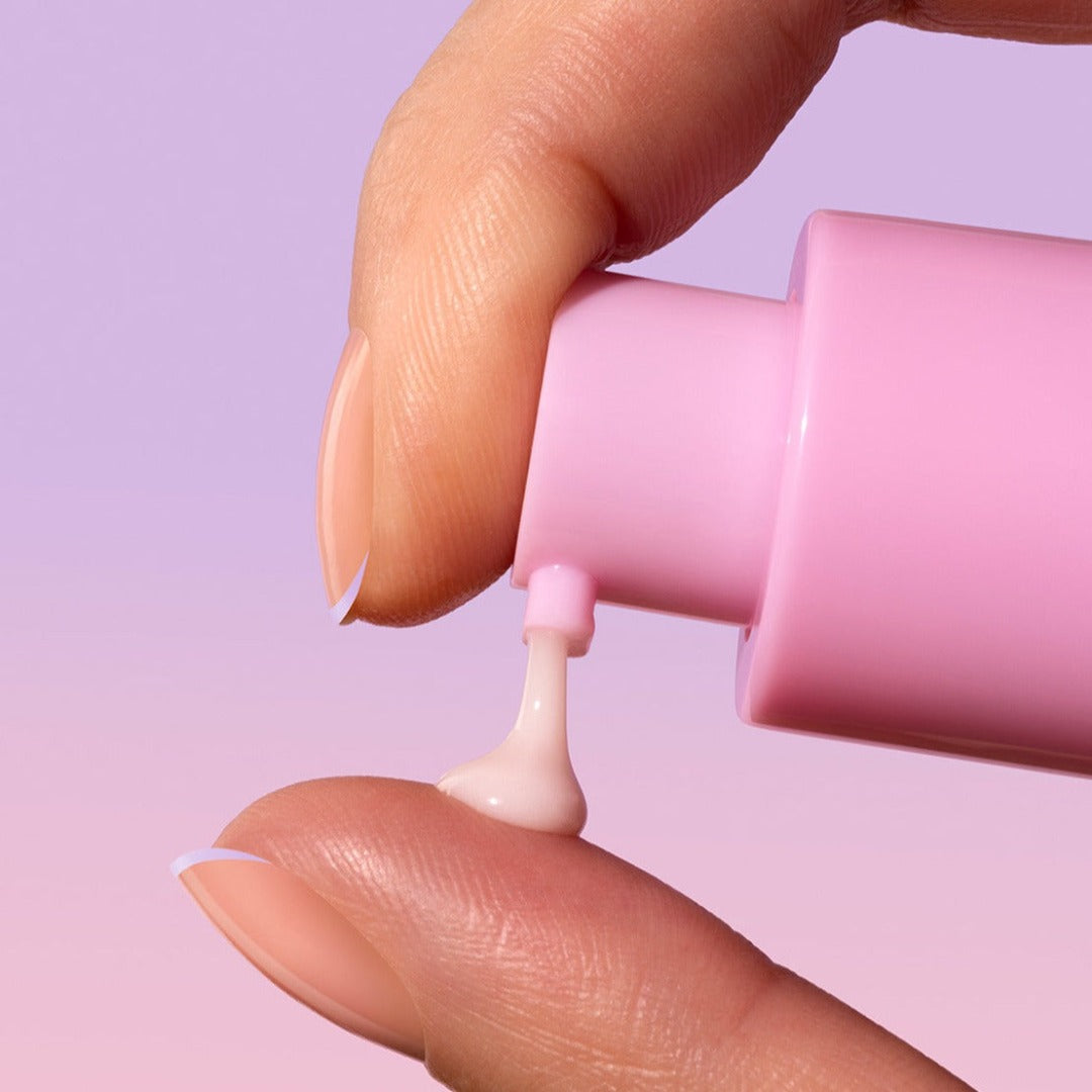Model applying Sand & Sky Pro Youth Dark Spot Serum to their fingers