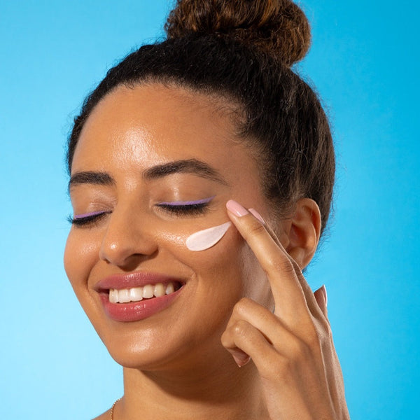 Model applying Sand & Sky Tinted Glow Primer SPF30 to their face