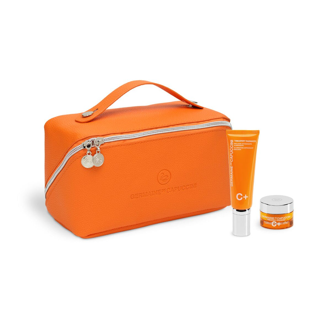Orange cosmetic bag with skincare products on a white background
