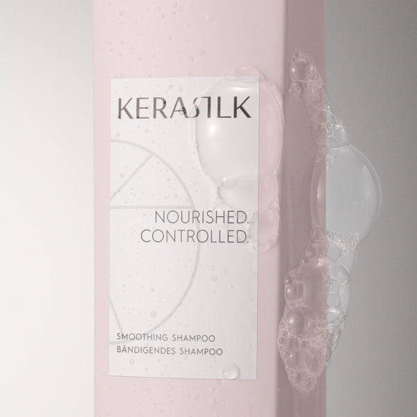 Kerastik shampoo bottle with a pink gradient and visible shampoo being applied.