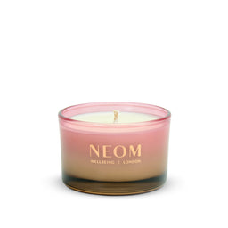 Neom candle with a gradient design on a white background