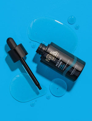 Bondi Sands Self Tan Drops Dark poured onto a blue surface