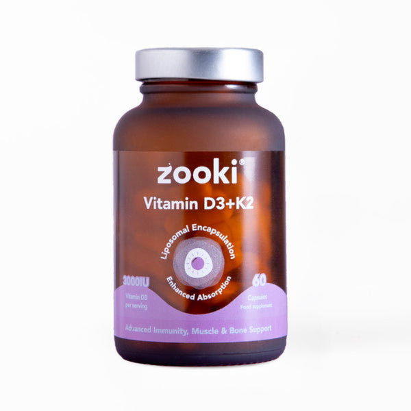 A brown amber bottle of Zooki Vitamin D3+K2 dietary supplement with a silver cap and a purple label accent, shown on a clean white background.