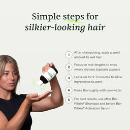 Woman holding a hair care product with instructions for silkier-looking hair on a white background